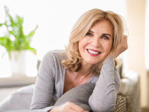 menopausal age woman smiling on a couch